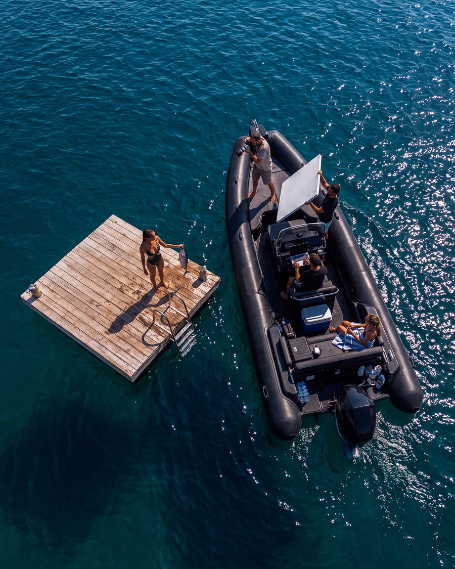 Aerial view of the shoot: crew on a boat beside the floating platform